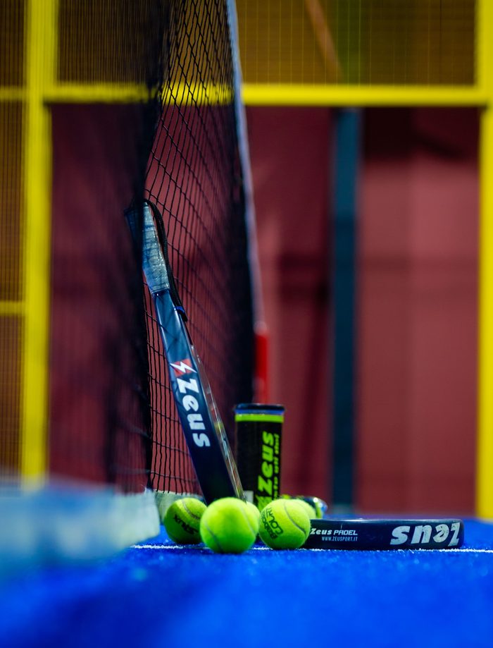 Racket and balls at the net